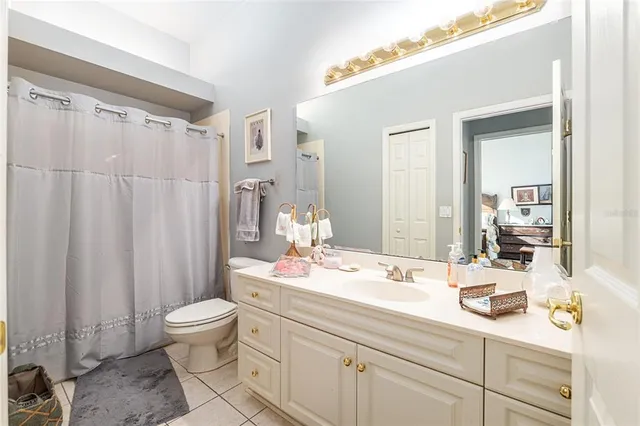 a bathroom with a sink a toilet and shower curtain