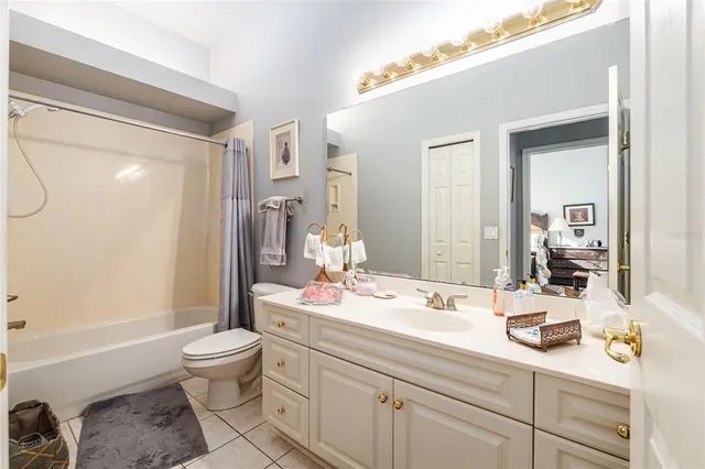 a bathroom with a granite countertop sink a toilet and shower