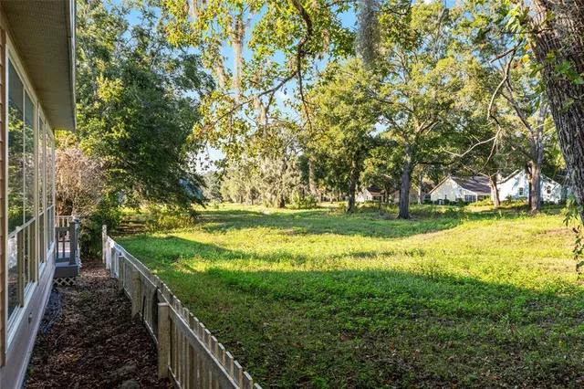 a view of a yard with large trees