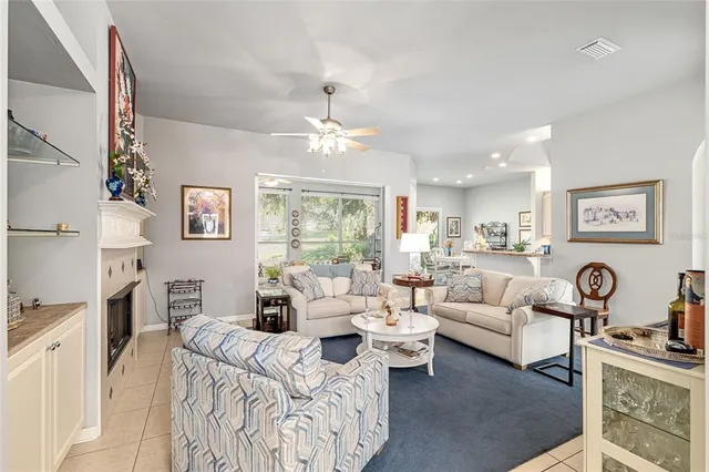 a living room with furniture or chandelier and a wooden floor