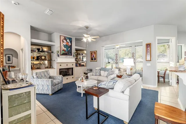 a living room with fireplace furniture and a flat screen tv