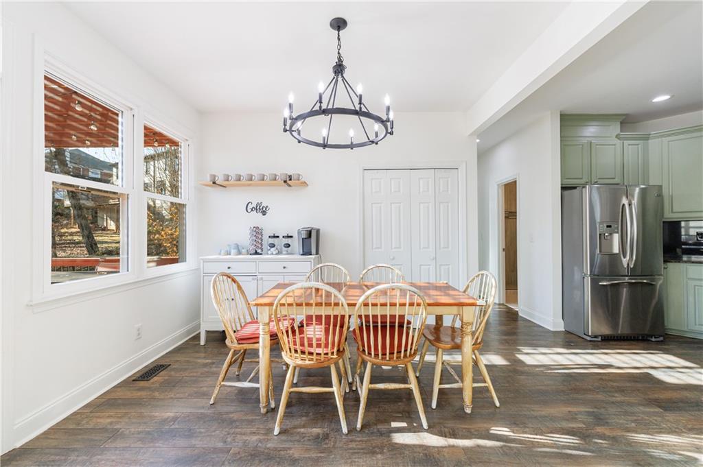 6010 Masters Club Drive Suwanee, GA 30024 - Photo 11 of 65 a dining room with furniture a chandelier and window