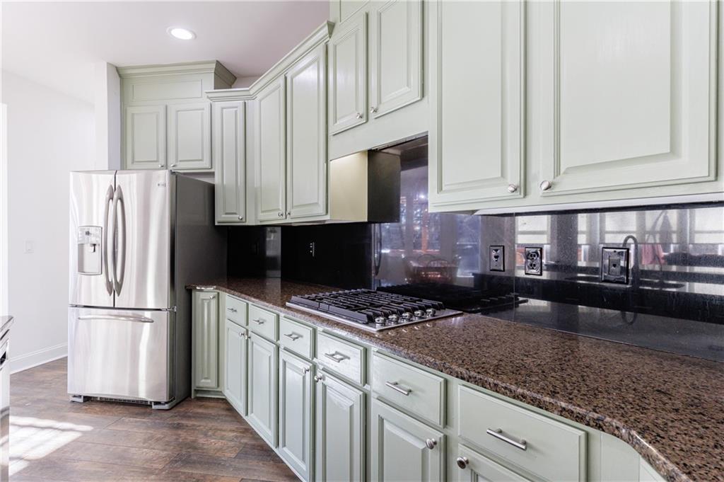 6010 Masters Club Drive Suwanee, GA 30024 - Photo 15 of 65 a kitchen with granite countertop a sink a stove and refrigerator