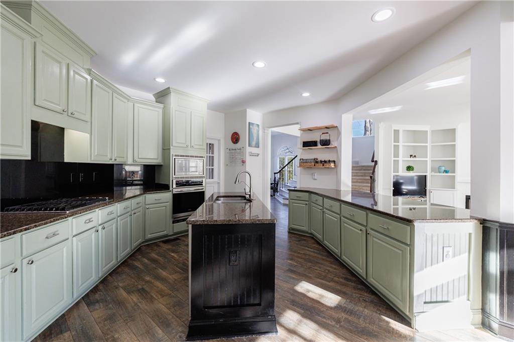 6010 Masters Club Drive Suwanee, GA 30024 - Photo 16 of 65 a kitchen with counter top space cabinets and stainless steel appliances