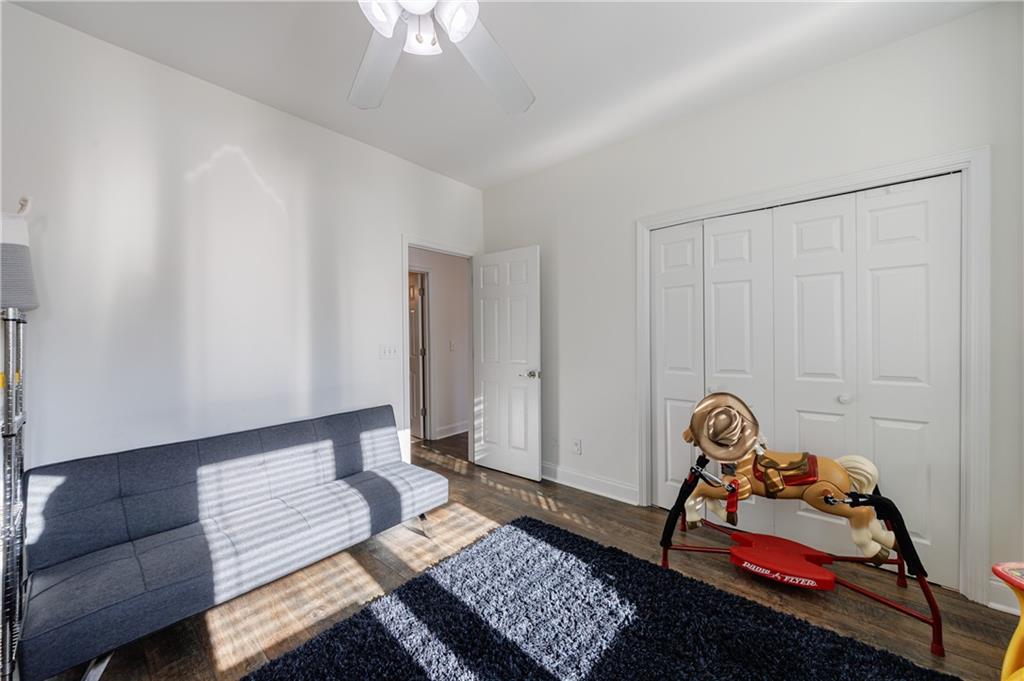 6010 Masters Club Drive Suwanee, GA 30024 - Photo 19 of 65 a bedroom with a bed and a couch