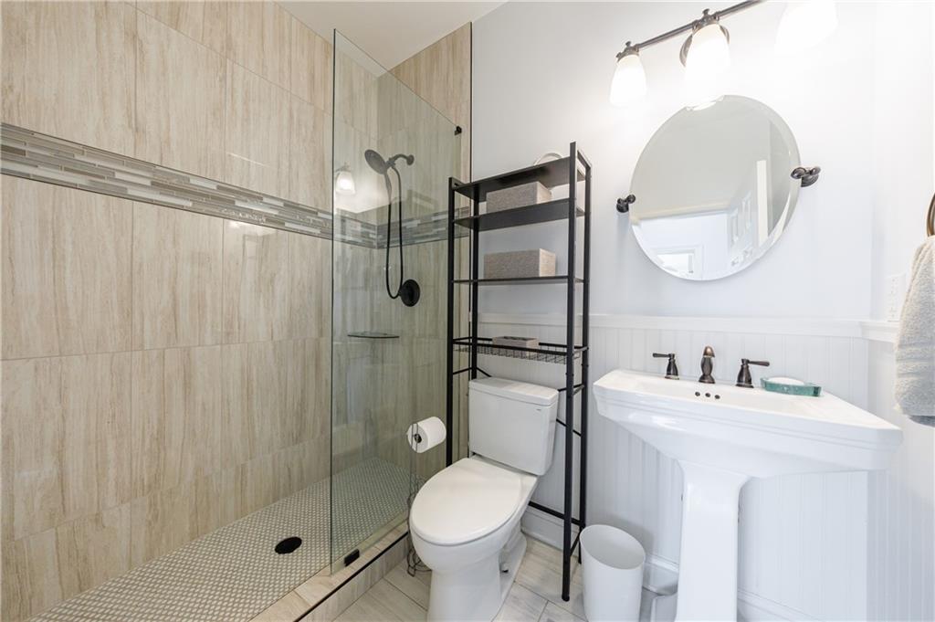 6010 Masters Club Drive Suwanee, GA 30024 - Photo 20 of 65 a bathroom with a toilet sink and shower