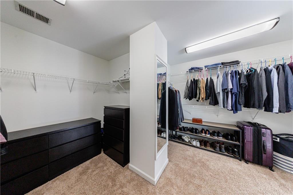 6010 Masters Club Drive Suwanee, GA 30024 - Photo 28 of 65 a view of walk in closet with clothes and shoes