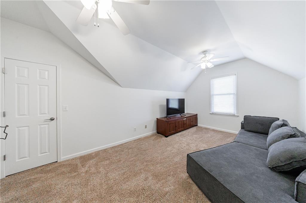 6010 Masters Club Drive Suwanee, GA 30024 - Photo 30 of 65 a living room with furniture and a flat screen tv
