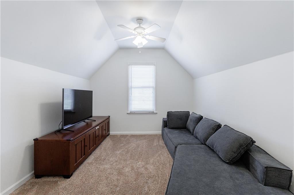 6010 Masters Club Drive Suwanee, GA 30024 - Photo 31 of 65 a living room with furniture and a flat screen tv