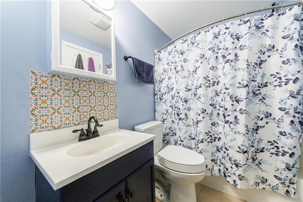 6010 Masters Club Drive Suwanee, GA 30024 - Photo 43 of 65 a bathroom with a sink toilet and mirror