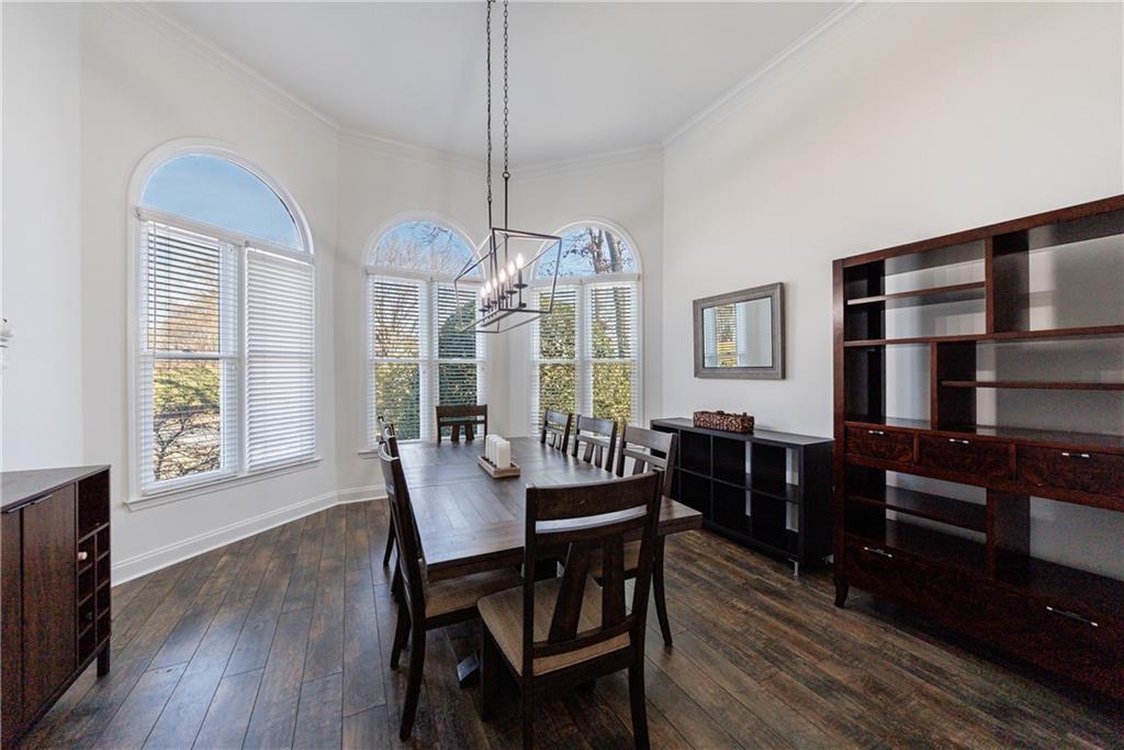 6010 Masters Club Drive Suwanee, GA 30024 - Photo 49 of 65 a view of a dining room with furniture window and wooden floor