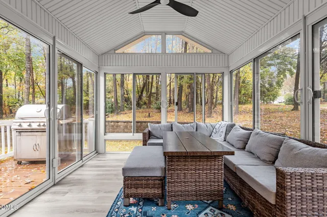 a living room with furniture and a floor to ceiling window