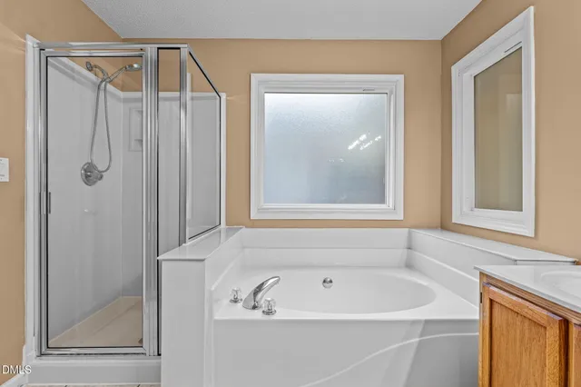 a bathroom with a bathtub and a shower