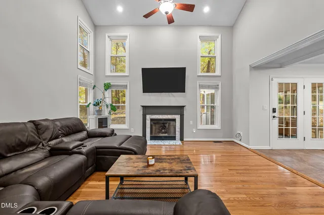 a living room with furniture fireplace and flat screen tv