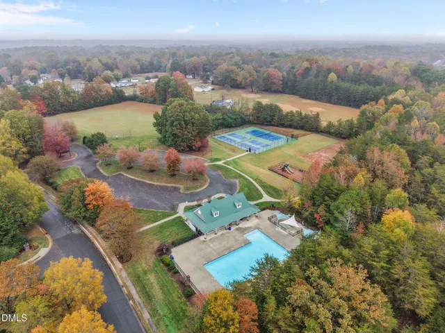 an aerial view of a house with a yard and lake view