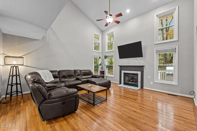 a living room with furniture a fireplace and a flat screen tv