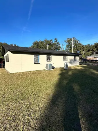 a view of a house with a yard and a garage