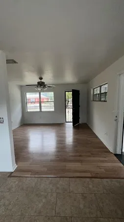 a view of a livingroom with wooden floor and window