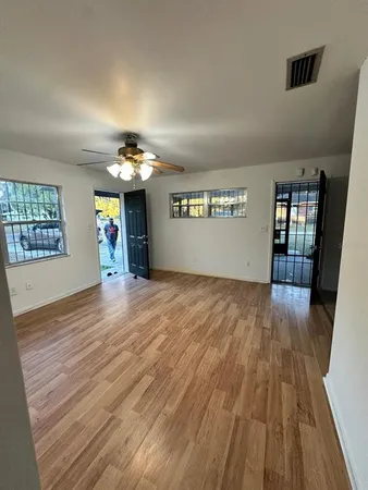 wooden floor in an empty room with a window