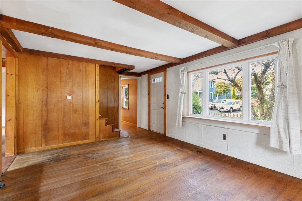 4 Arrowhead Trail Ipswich, MA 01938 - Photo 21 of 39 a view of an empty room with window and wooden floor