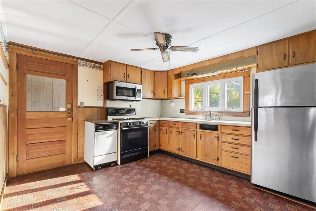 4 Arrowhead Trail Ipswich, MA 01938 - Photo 22 of 39 a kitchen with stainless steel appliances granite countertop a refrigerator a stove a sink and a microwave
