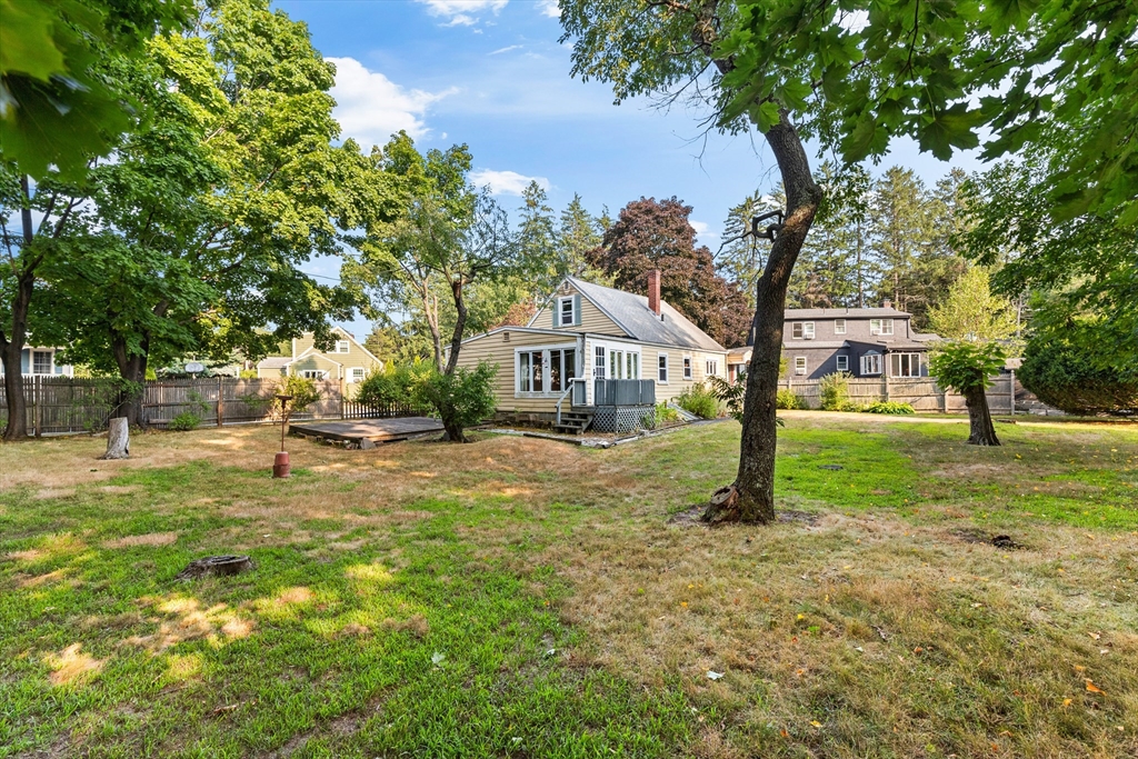 4 Arrowhead Trail Ipswich, MA 01938 - Photo 6 of 39 a house with green field in front of it