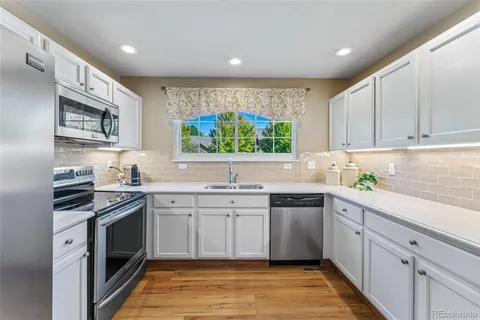 a kitchen with stainless steel appliances a stove sink and cabinets