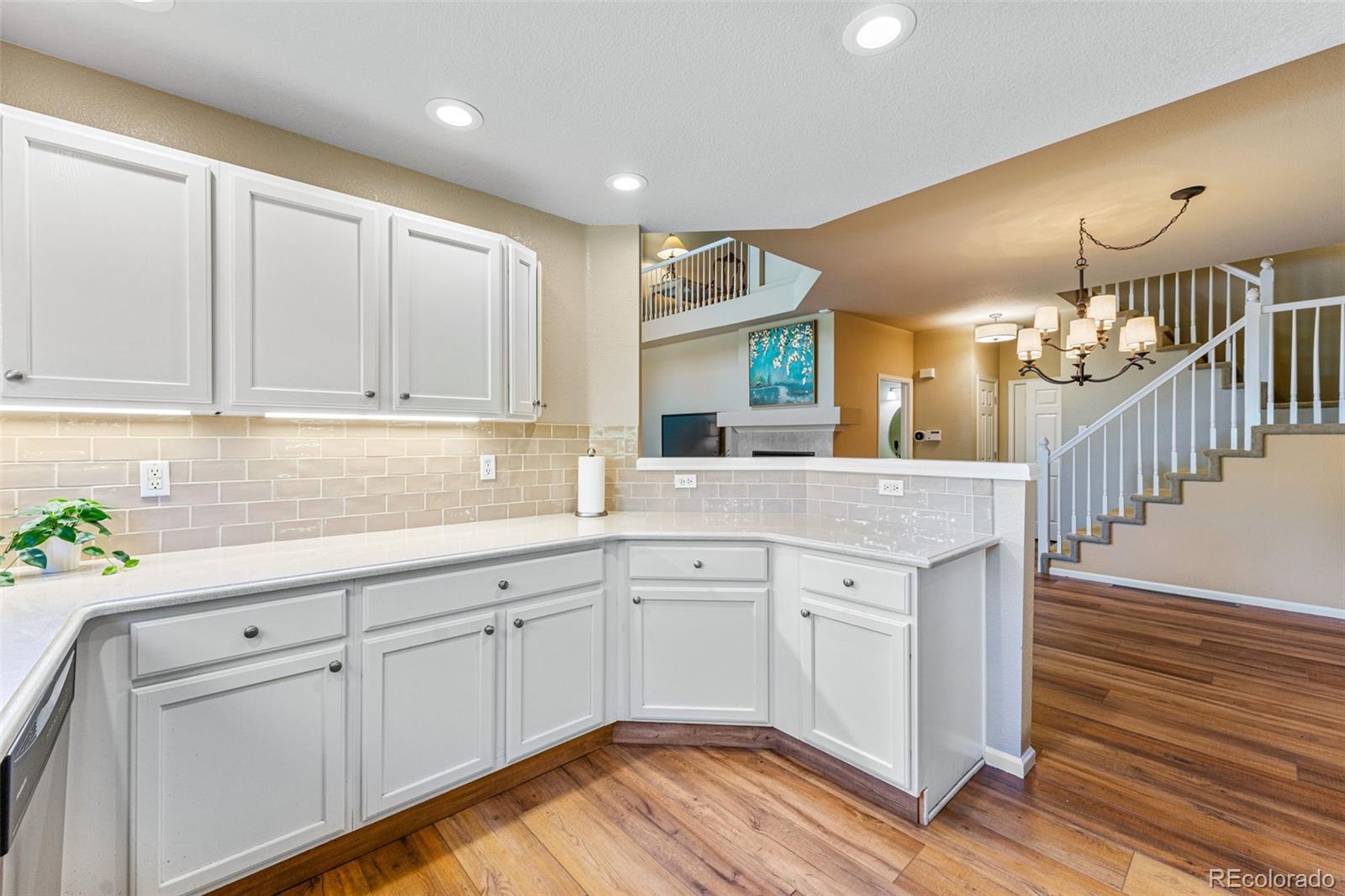 41 Quince Street Denver, CO 80230 - Photo 14 of 47 a kitchen with cabinets a sink and dishwasher in it