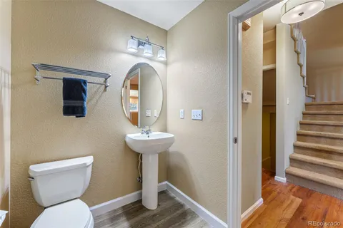 a view of bathroom with a toilet and a mirror