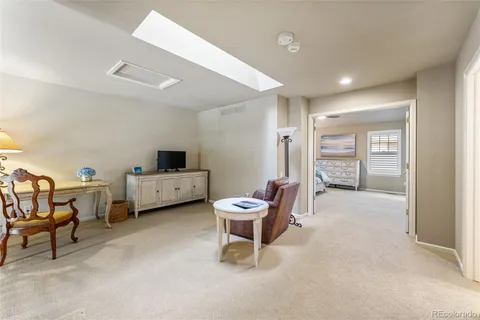 a living room with furniture and a chair