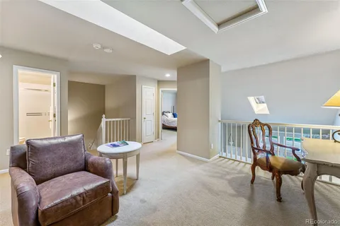 a living room with furniture a lamp and a large window
