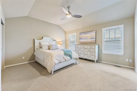 a bed room with a bed and a ceiling fan