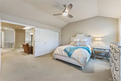 a spacious bedroom with a bed and a chandelier