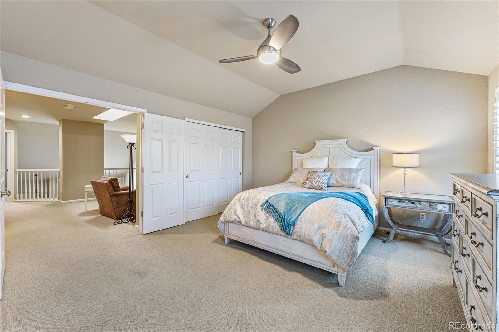 41 Quince Street Denver, CO 80230 - Photo 22 of 47 a spacious bedroom with a bed and a chandelier