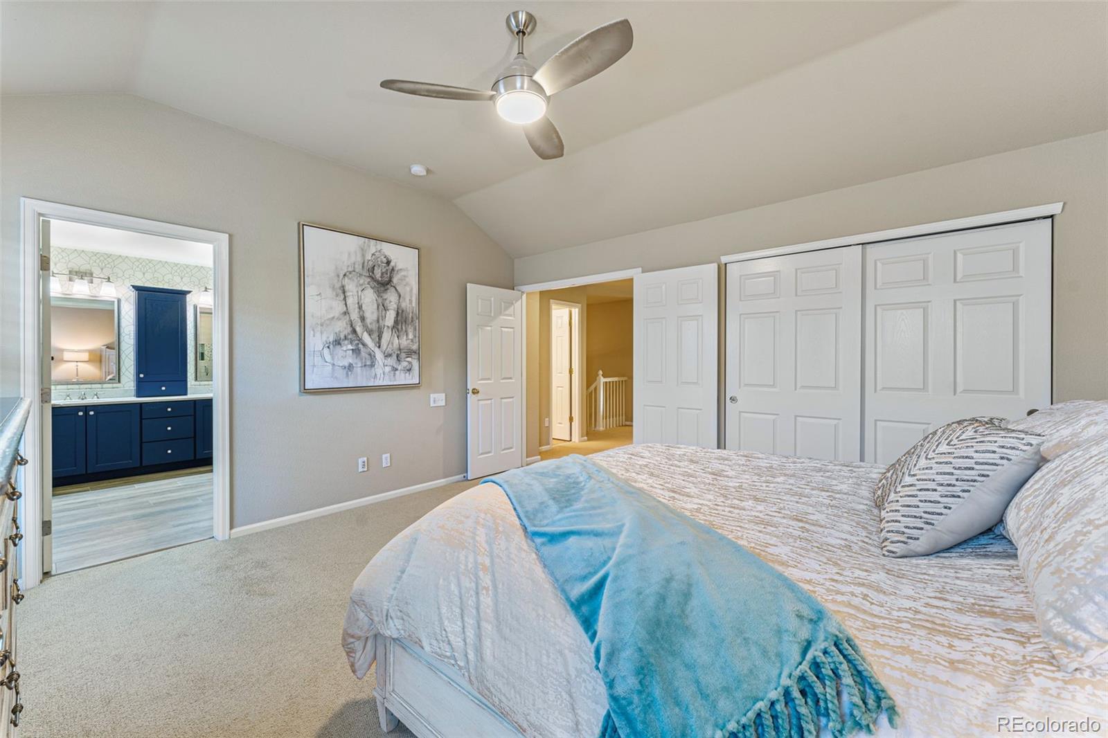 41 Quince Street Denver, CO 80230 - Photo 24 of 47 a bedroom with a large bed and a chandelier