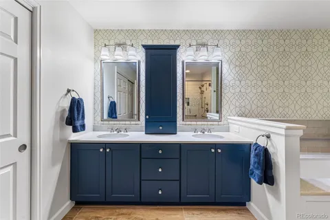 a bathroom with a double vanity sink and mirror