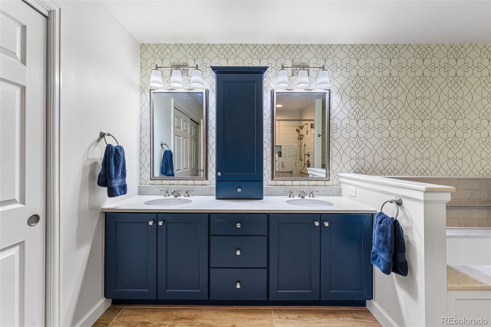 41 Quince Street Denver, CO 80230 - Photo 25 of 47 a bathroom with a double vanity sink and mirror