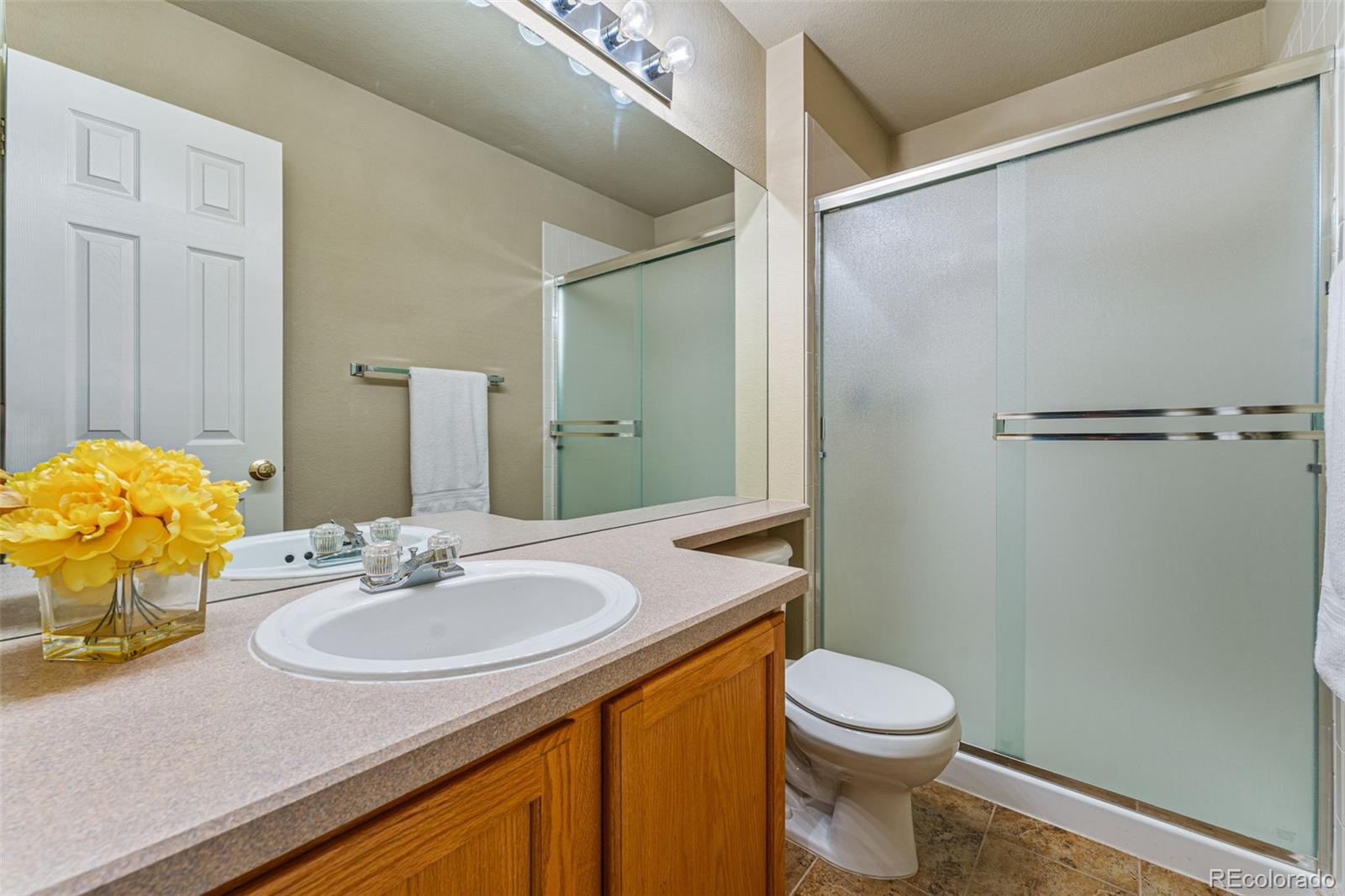 41 Quince Street Denver, CO 80230 - Photo 29 of 47 a bathroom with a sink toilet and shower