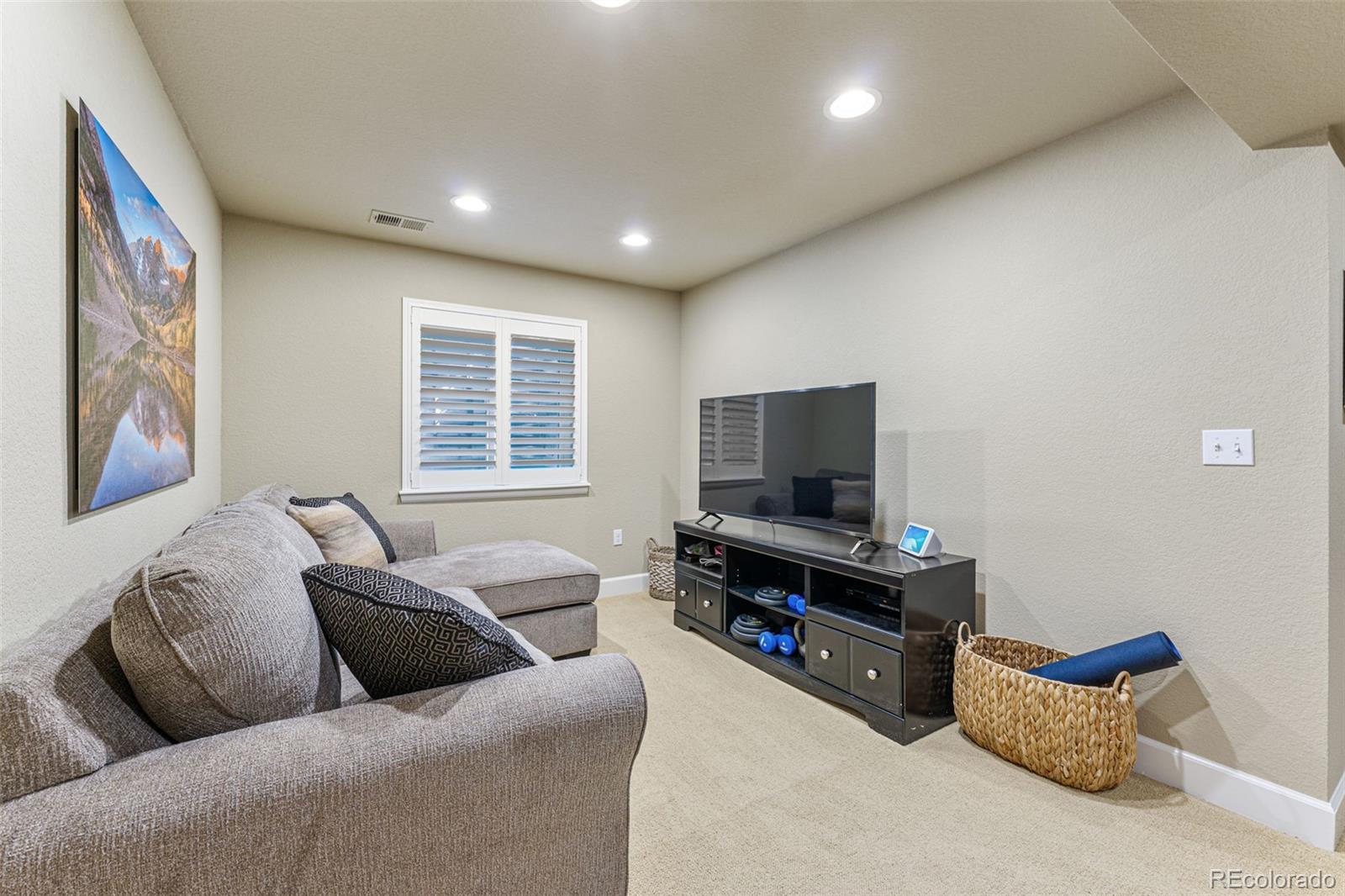 41 Quince Street Denver, CO 80230 - Photo 31 of 47 a living room with furniture and a flat screen tv