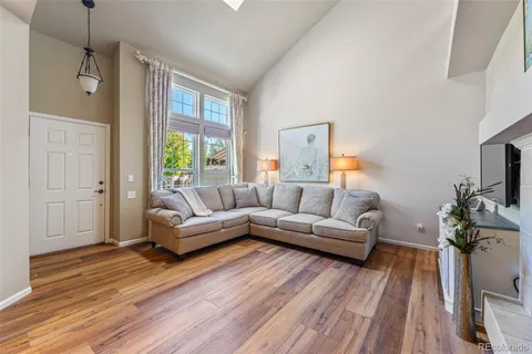 a living room with furniture a ceiling fan and a window