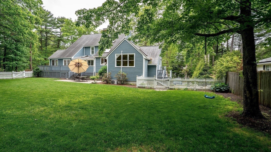 142 Baker Street Walpole, MA 02081 - Photo 40 of 42 a front view of a house with yard and green space