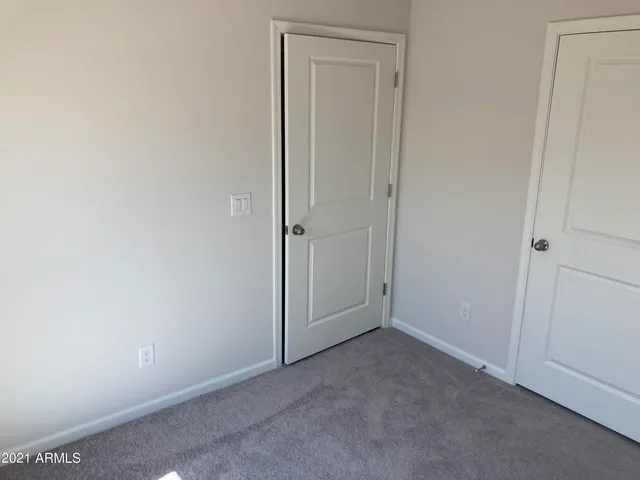 an empty room with closet area