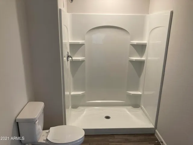 a view of a house with a wooden fence