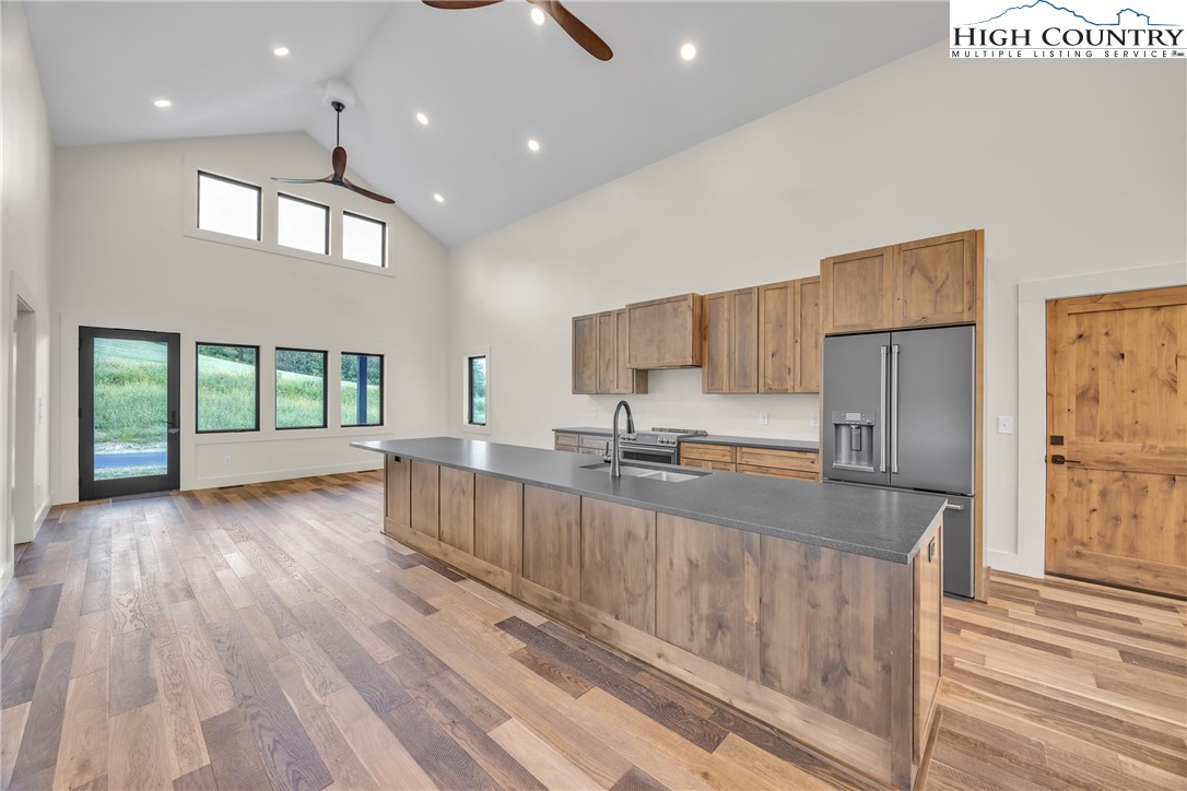 Range View Drive, Unit TBD Jefferson, NC 28640 - Photo 14 of 46 a large kitchen with stainless steel appliances granite countertop a refrigerator a sink dishwasher a stove and a dining table with wooden floor