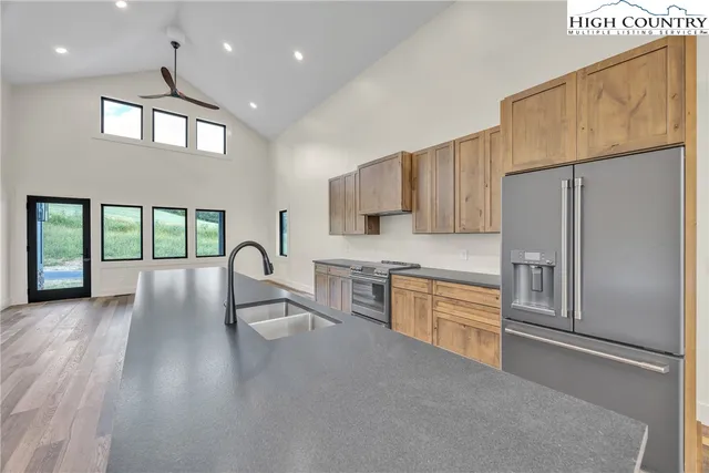 a room with a window a ceiling fan and wooden floor