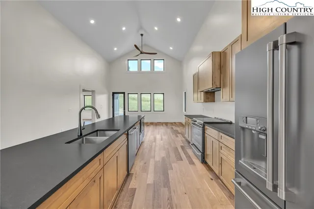a bathroom with a granite countertop sink a toilet and shower