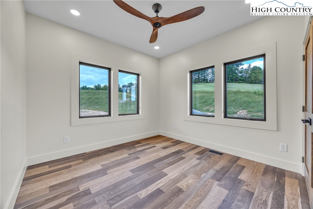 Range View Drive, Unit TBD Jefferson, NC 28640 - Photo 19 of 46 a room with a window a ceiling fan and wooden floor