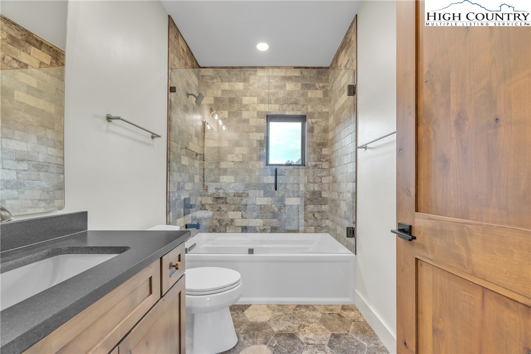 Range View Drive, Unit TBD Jefferson, NC 28640 - Photo 21 of 46 a bathroom with a granite countertop sink a toilet and shower