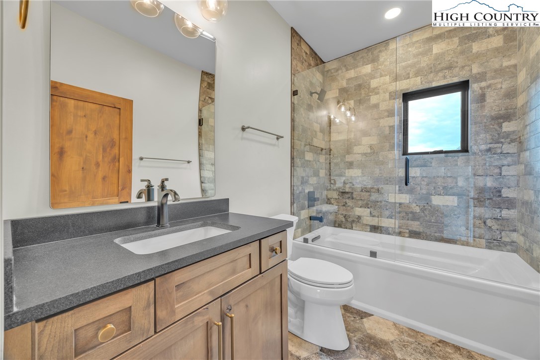 Range View Drive, Unit TBD Jefferson, NC 28640 - Photo 22 of 46 a bathroom with a granite countertop sink a toilet and shower