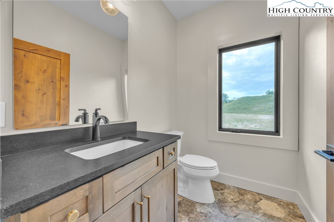 Range View Drive, Unit TBD Jefferson, NC 28640 - Photo 26 of 46 a bathroom with a granite countertop sink a toilet and a window